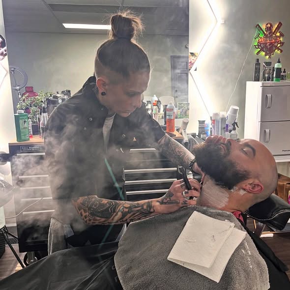 Nae performing a hot towel straight razor shave at The Edge Barbershop Linton IN